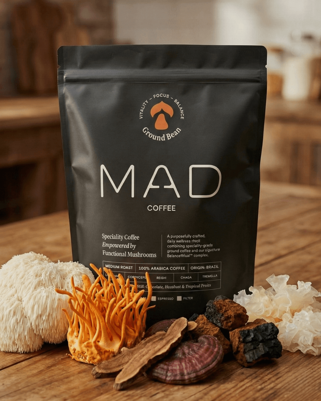 A bag of MAD Coffee on a table, with the five whole mushrooms laid out in front of it